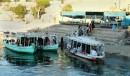 local ferry 2 * The green boats are the local ferries and here the people are streaming off the ferry after their day's work.  The white boat toward the right of the photo is the tourist boat. * 432 x 254 * (63KB)