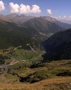 valley pano * A vertical panorama of the valley below to the mountains in the distance, looking east from Timmelsjoch.  The grassy area in the foreground is the near-vertical drop to the valley below. On this slope were the grazing cows, their bells gently clanging as they grazed. * 340 x 432 * (55KB)